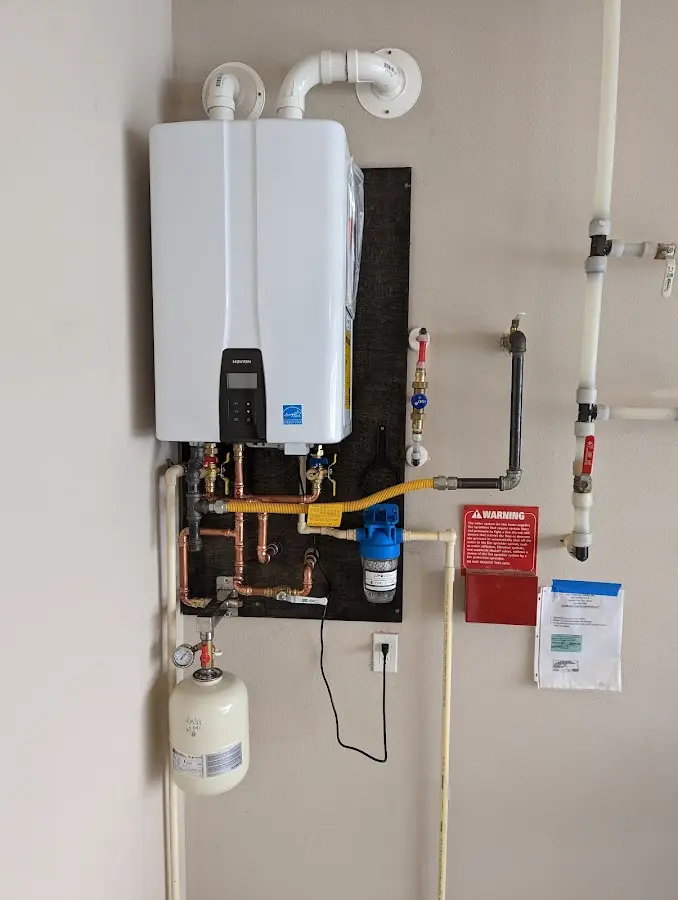 Professional plumber installing copper piping in a La Quinta home